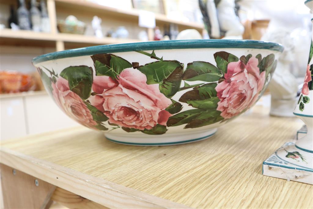 A Wemyss pottery Cabbage rose decorated toilet bowl, diameter 39cm, and a pair of Weymss style candlesticks by Griselda Hill pottery